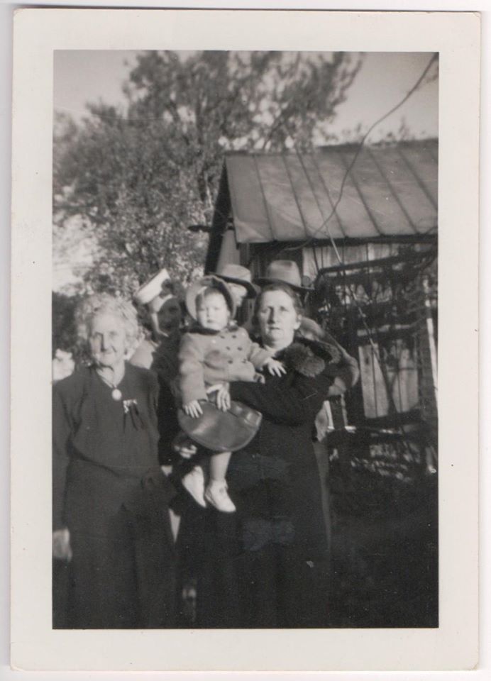 Vintage family snapshot of women and a child outdoors